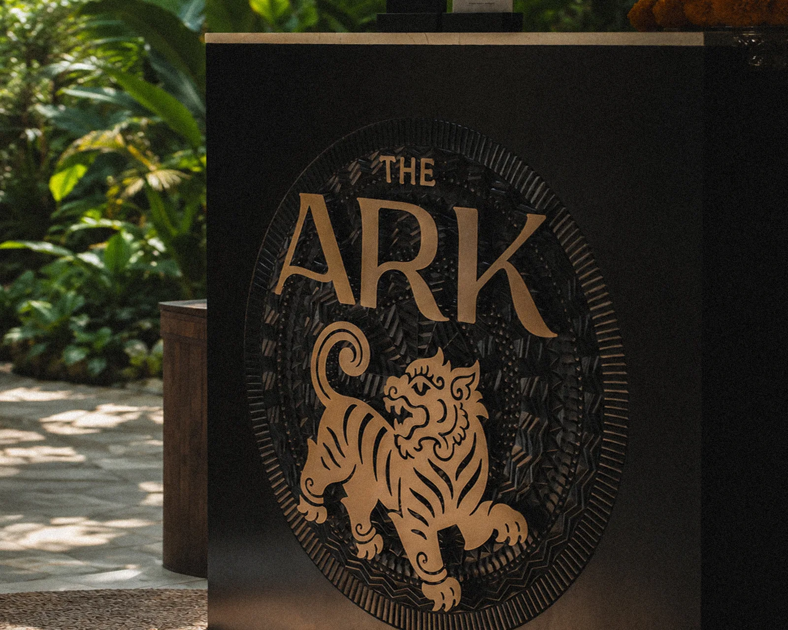 Custom carved wood panel with brass lettering at The Ark